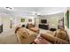 Comfortable living room featuring neutral tones, a ceiling fan, and sun-drenched windows, perfect for relaxation at 4345 Idlewood Dr, Cumming, GA 30040