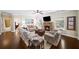 Cozy living room featuring a stone fireplace, plush seating, and warm hardwood floors at 4345 Idlewood Dr, Cumming, GA 30040