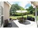 Covered patio features an umbrella-covered table with chairs and a grill at 4345 Idlewood Dr, Cumming, GA 30040