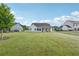 Large backyard with lush green lawn and a covered porch, perfect for outdoor activities and relaxation at 4720 Down Setting Rd, Cumming, GA 30028