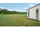 Expansive backyard featuring a lush lawn and a partial view of the home's exterior with supporting pillars at 4720 Down Setting Rd, Cumming, GA 30028