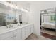 Bathroom with double vanity, modern fixtures, and access to the glass enclosed shower and adjacent main bedroom at 4720 Down Setting Rd, Cumming, GA 30028