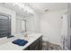 Bright bathroom with a modern vanity, large mirror, and tiled floors at 4720 Down Setting Rd, Cumming, GA 30028