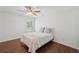 Bright bedroom with hardwood floors, a ceiling fan and a window with plantation shutters at 4720 Down Setting Rd, Cumming, GA 30028