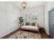 Charming bedroom with plantation shutters, stylish lighting, and hardwood floors at 4720 Down Setting Rd, Cumming, GA 30028