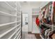 Walk-in closet with custom shelving and rods for ample storage and organization at 4720 Down Setting Rd, Cumming, GA 30028