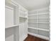 Spacious walk-in closet with extensive shelving and hanging rods for organized storage at 4720 Down Setting Rd, Cumming, GA 30028