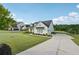 Charming modern farmhouse with a well-manicured lawn and a long driveway leading to the attached garage at 4720 Down Setting Rd, Cumming, GA 30028