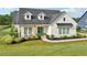 Attractive home with a green front door, manicured lawn, and lush landscaping at 4720 Down Setting Rd, Cumming, GA 30028