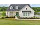 Beautiful home with a green front door, manicured lawn, and lush landscaping at 4720 Down Setting Rd, Cumming, GA 30028