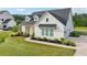 Charming home with white siding, dark roof, manicured lawn, and lush landscaping at 4720 Down Setting Rd, Cumming, GA 30028