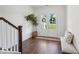 Charming foyer with hardwood floors, bench seating, and double doors adorned with wreaths at 4720 Down Setting Rd, Cumming, GA 30028