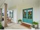 Inviting covered front porch with rocking chairs, a welcome mat, and double doors with floral wreaths at 4720 Down Setting Rd, Cumming, GA 30028