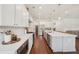 Bright kitchen features white cabinets, stainless appliances, granite countertops, and hardwood floors at 4720 Down Setting Rd, Cumming, GA 30028