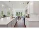 Stylish kitchen boasts a long island, granite counters, stainless appliances, and backyard views at 4720 Down Setting Rd, Cumming, GA 30028