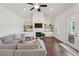 Inviting living room with hardwood floors, fireplace, built-ins, and a seamless transition to the outdoors at 4720 Down Setting Rd, Cumming, GA 30028