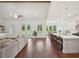 Open concept living room with vaulted ceilings, hardwood floors, access to the backyard and connected kitchen at 4720 Down Setting Rd, Cumming, GA 30028