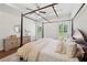 Bedroom with a four-poster bed, tray ceilings, plantation shutters and an area rug over hardwood flooring at 4720 Down Setting Rd, Cumming, GA 30028