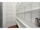Walk-in pantry with wood floors and white shelving with lots of storage at 4720 Down Setting Rd, Cumming, GA 30028