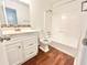 Clean bathroom featuring a vanity, toilet, and shower/tub combo with a white tile surround at 5968 Hilltop Dr, Douglasville, GA 30135