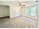 Spacious bedroom featuring carpeted floors, ceiling fan, and ample natural light at 5968 Hilltop Dr, Douglasville, GA 30135