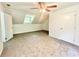Bright bedroom boasting carpet floors, dormer window, and a modern ceiling fan at 5968 Hilltop Dr, Douglasville, GA 30135