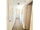 Hallway featuring carpeted floors and white doors to other rooms at 5968 Hilltop Dr, Douglasville, GA 30135