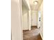 Hallway with wood floors leading to a kitchen and other rooms at 5968 Hilltop Dr, Douglasville, GA 30135