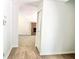 Hallway with wood floor, neutral walls leading to the living room at 5968 Hilltop Dr, Douglasville, GA 30135