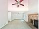 Bright living room featuring carpeted floors, a brick fireplace, and a ceiling fan at 5968 Hilltop Dr, Douglasville, GA 30135