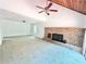 Bright living room featuring carpeted floors, a brick fireplace, and a ceiling fan at 5968 Hilltop Dr, Douglasville, GA 30135