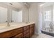 Bathroom featuring a double vanity, a large mirror, and access to a separate toilet and shower at 1360 Mount Mickinley Dr, Grayson, GA 30017