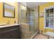 Bright bathroom featuring a glass-enclosed shower, tiled floors and modern vanity with a gray framed mirror at 1360 Mount Mickinley Dr, Grayson, GA 30017