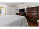 Bedroom suite featuring a television, wooden dresser, closet and a full sized bed with matching quilts at 1360 Mount Mickinley Dr, Grayson, GA 30017