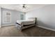 Cozy bedroom with a wooden bed frame, plush carpet, and natural light from two windows at 1360 Mount Mickinley Dr, Grayson, GA 30017