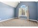 Cozy bedroom with an arched window, plush carpet, and calming blue walls at 1360 Mount Mickinley Dr, Grayson, GA 30017