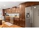 Kitchen featuring stainless steel appliances, granite counters, and wooden cabinets with a stainless refrigerator at 1360 Mount Mickinley Dr, Grayson, GA 30017