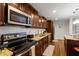 Updated kitchen featuring stainless steel appliances, granite countertops, and wooden cabinets at 1360 Mount Mickinley Dr, Grayson, GA 30017
