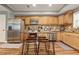 Modern kitchen features stainless steel appliances, wooden cabinets, and an island with bar stool seating at 1360 Mount Mickinley Dr, Grayson, GA 30017