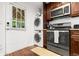 Kitchen and laundry room area with stainless steel appliances, dark cabinets, and a back door at 1360 Mount Mickinley Dr, Grayson, GA 30017