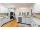 Modern kitchen featuring white cabinets, granite countertops, stainless steel appliances, and hardwood floors at 1360 Mount Mickinley Dr, Grayson, GA 30017