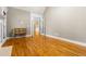 Spacious room featuring hardwood floors, decorative trim, and an adjacent room through open french doors at 1360 Mount Mickinley Dr, Grayson, GA 30017