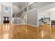 Elegant living space featuring hardwood floors, a staircase with wrought iron railings, and views to the kitchen at 1360 Mount Mickinley Dr, Grayson, GA 30017