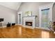 Bright living room featuring a cozy fireplace, hardwood floors, and large windows providing natural light at 1360 Mount Mickinley Dr, Grayson, GA 30017