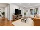 Living room featuring hardwood floors, recessed lighting, and a large TV at 1360 Mount Mickinley Dr, Grayson, GA 30017