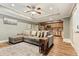 Open-concept living room features a plush sectional sofa, hardwood floors, and access to the kitchen area at 1360 Mount Mickinley Dr, Grayson, GA 30017
