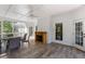 Inviting sunroom with a fireplace, offering natural light, a ceiling fan, and a table for seating at 1360 Mount Mickinley Dr, Grayson, GA 30017