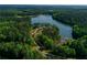 Scenic aerial view showcases a lake surrounded by a lush green forest at 1383 Van Allen Ct, Dacula, GA 30019