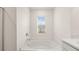 Bright bathroom featuring a large tub and a window with natural light at 1383 Van Allen Ct, Dacula, GA 30019