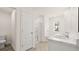 Well-lit bathroom featuring a separate shower and tub combo and double sink vanity at 1383 Van Allen Ct, Dacula, GA 30019